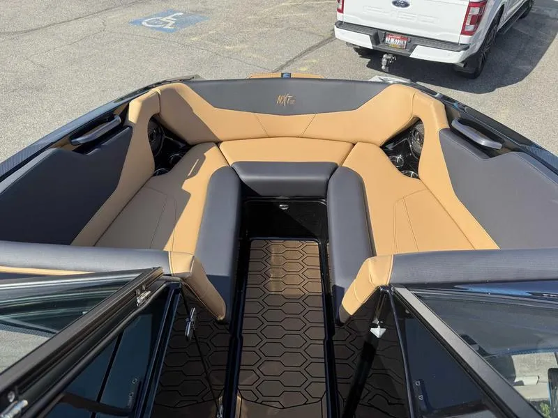 Slide: The Image of 2025 MasterCraft NXT22 boat interior with tan and gray seating, hexagonal floor pattern. - 11