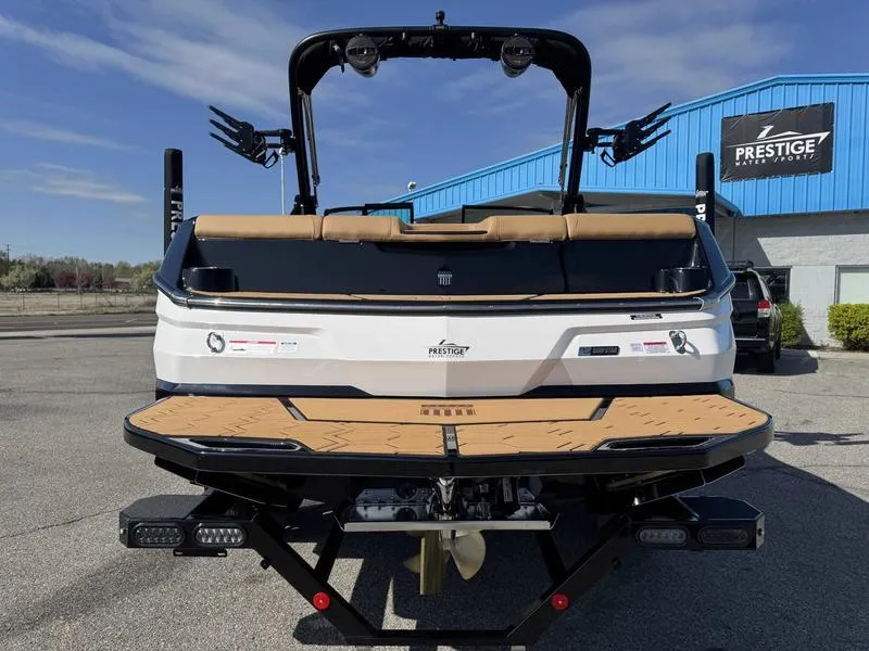 Slide: The Image of 2025 MasterCraft NXT22 boat rear view at Prestige dealership. - 6