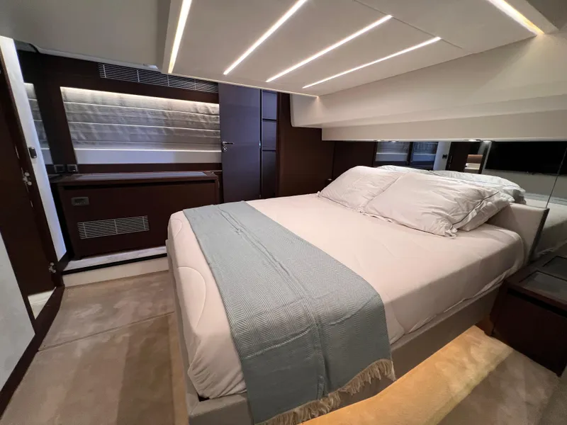 Slide: The Image of Luxurious bedroom interior of 2023 Prestige 520 yacht with modern design and ambient lighting. - 17