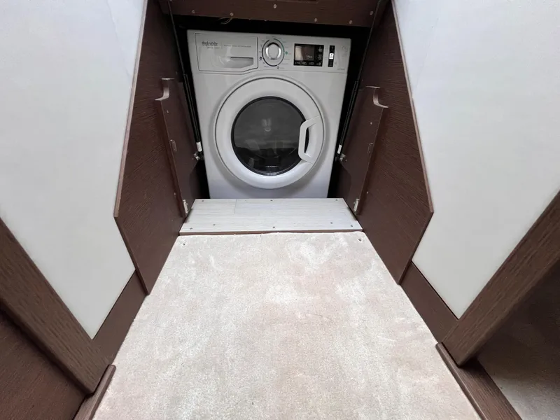 Slide: The Image of Laundry area with a modern washing machine in a 2023 Prestige 520 model. - 23