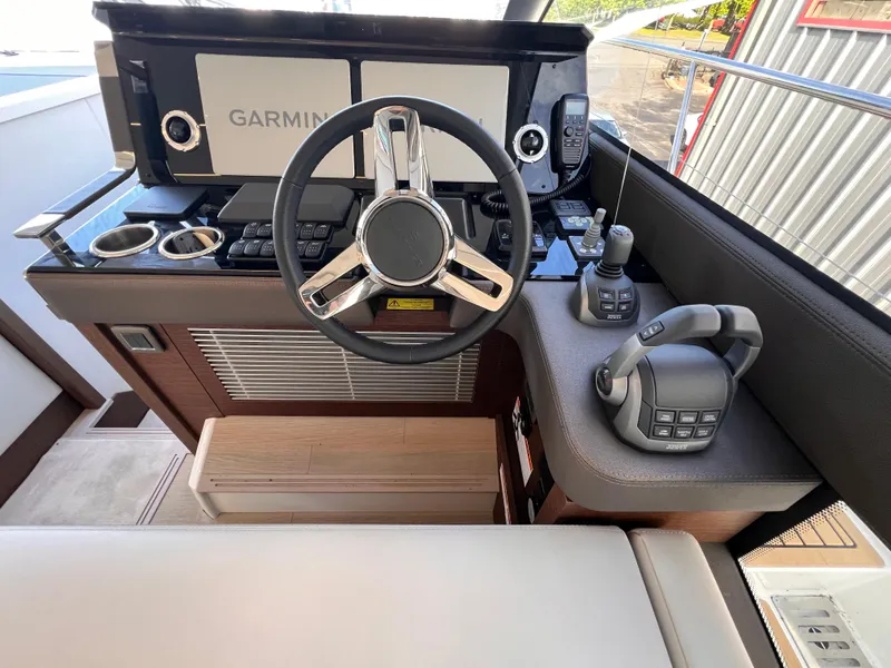 Slide: The Image of Helm of 2023 Prestige 520 yacht with Garmin navigation system and modern controls. - 5