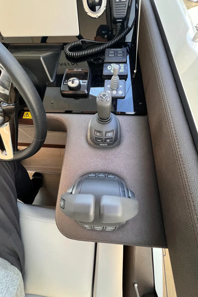 Slide: The Image of Control panel of a 2023 Prestige 520 yacht with joystick and throttle. - 6