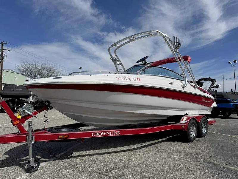 Slide: The Image of 2008 Crownline 230LS boat on a red trailer under a clear blue sky. - 1