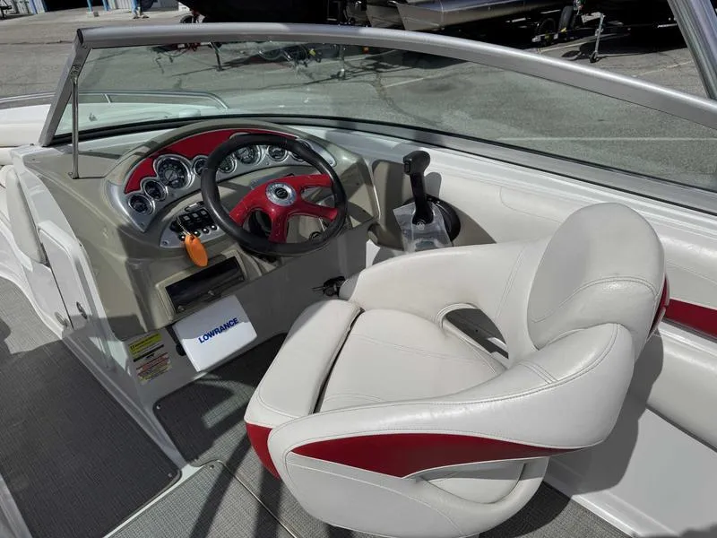 Slide: The Image of 2008 Crownline 230LS boat interior with steering wheel and white-red seating. - 10
