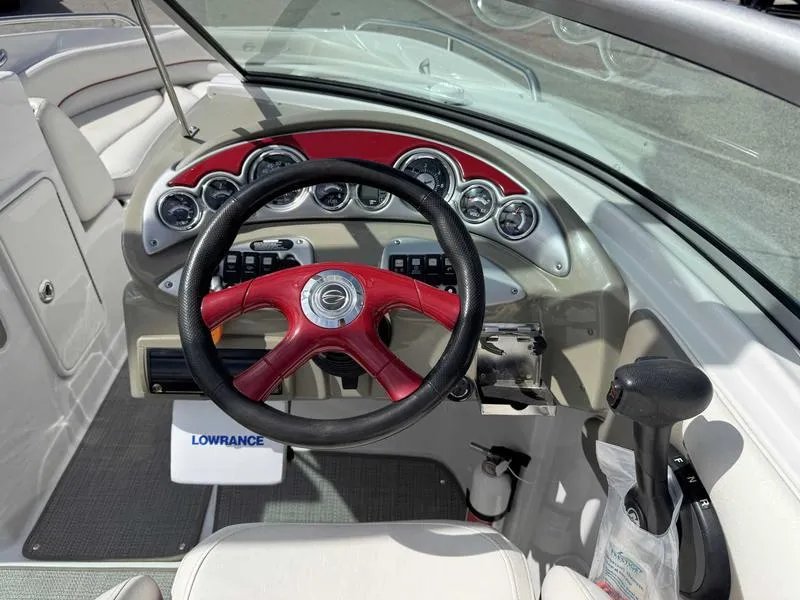 Slide: The Image of 2008 Crownline 230LS boat dashboard with red steering wheel and Lowrance equipment. - 11