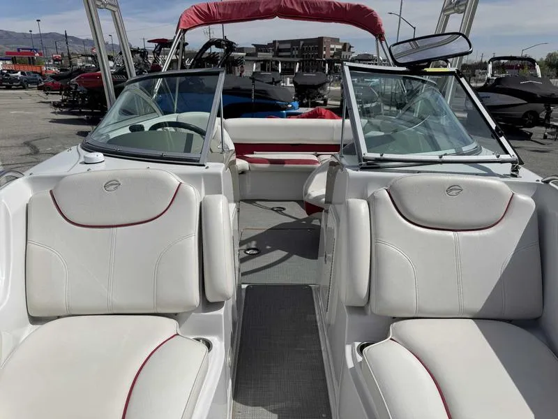 Slide: The Image of 2008 Crownline 230LS boat interior with white seating and red accents. - 13