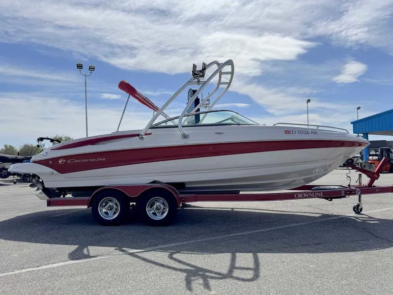 Slide: The Image of 2008 Crownline 230LS boat on trailer, red and white design, parked outdoors. - 5