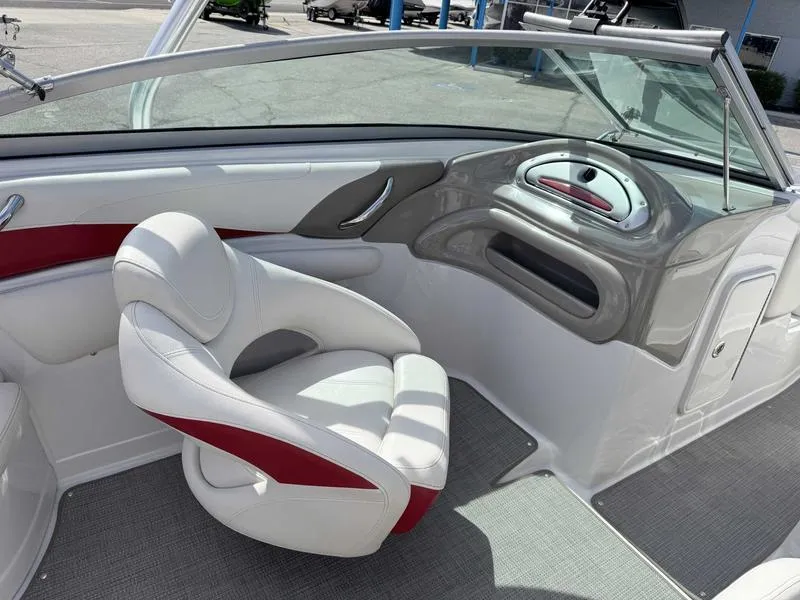 Slide: The Image of 2008 Crownline 230LS boat interior with white and red seating, sleek dashboard design. - 9