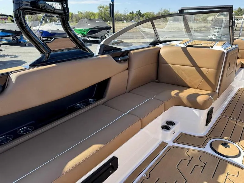 Slide: The Image of 2024 Moomba Max boat interior with tan seating and sleek design. - 10