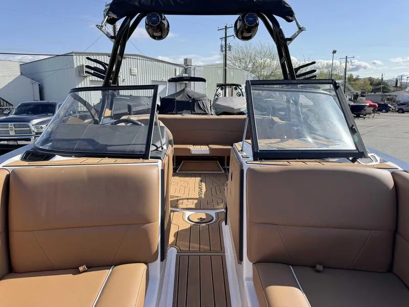 Slide: The Image of 2024 Moomba Max boat interior with tan seating and open deck layout. - 13