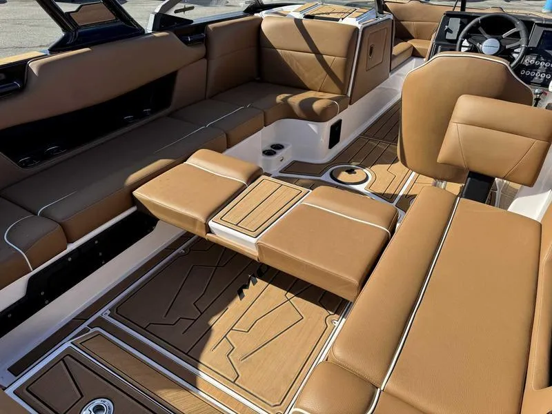 Slide: The Image of 2024 Moomba Max boat interior with brown leather seating and modern design. - 14