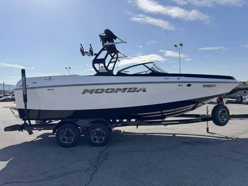 Slide: The Image of 2024 Moomba Max boat on trailer, sleek design, black and white color scheme, sunny day. - 4