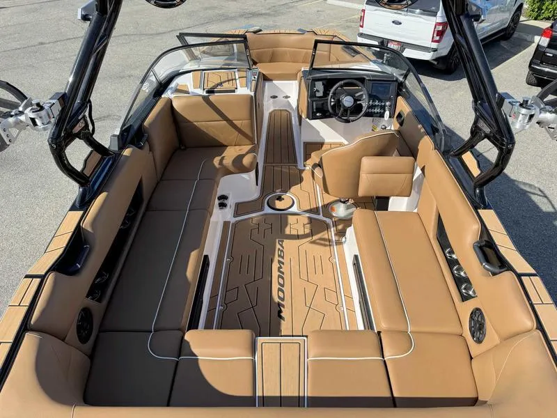 Slide: The Image of 2024 Moomba Max boat interior with tan seating and modern dashboard. - 8
