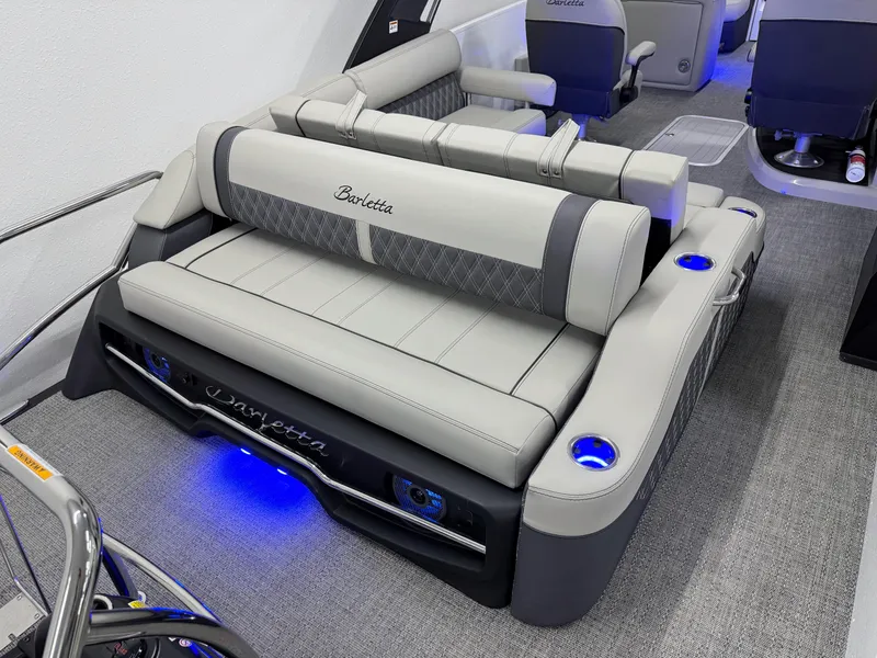 Slide: The Image of 2025 Barletta Reserve Leggera R26UCA boat interior with luxurious seating and blue LED lighting. - 19