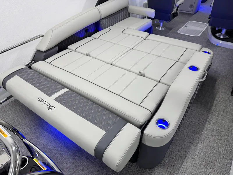 Slide: The Image of 2025 Barletta Reserve Leggera R26UCA boat interior with luxurious seating and cup holders. - 21