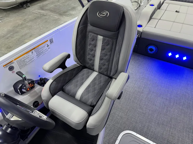 Slide: The Image of Captain's seat in 2025 Barletta Reserve Leggera R26UCA boat, featuring luxurious design and blue LED lighting. - 27