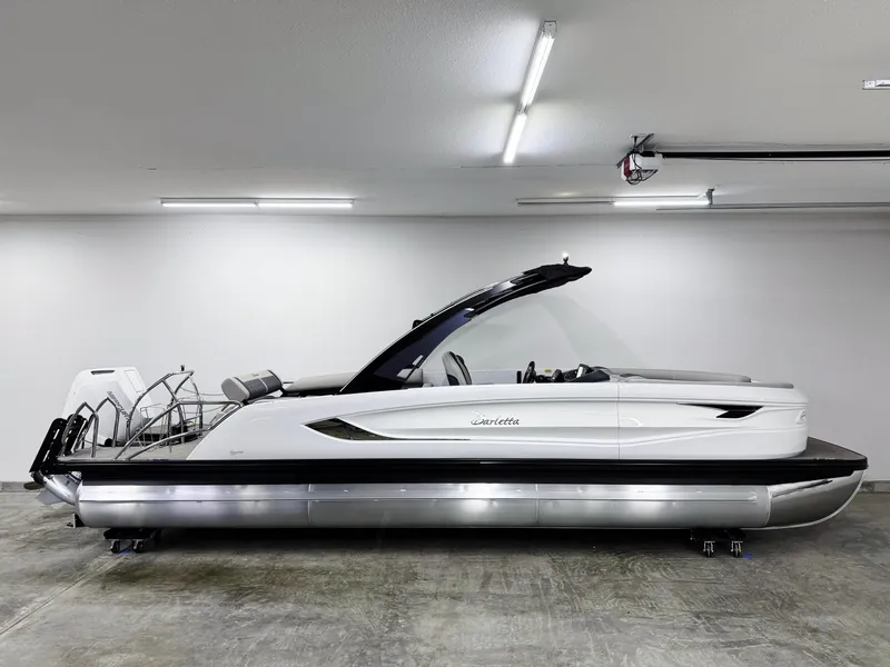 Slide: The Image of 2025 Barletta Reserve Leggera R26UCA pontoon boat in a well-lit garage. - 3
