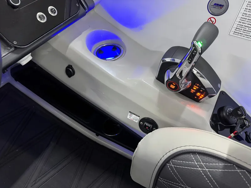 Slide: The Image of Control panel of 2025 Barletta Reserve Leggera R26UCA boat with illuminated throttle and cup holder. - 31