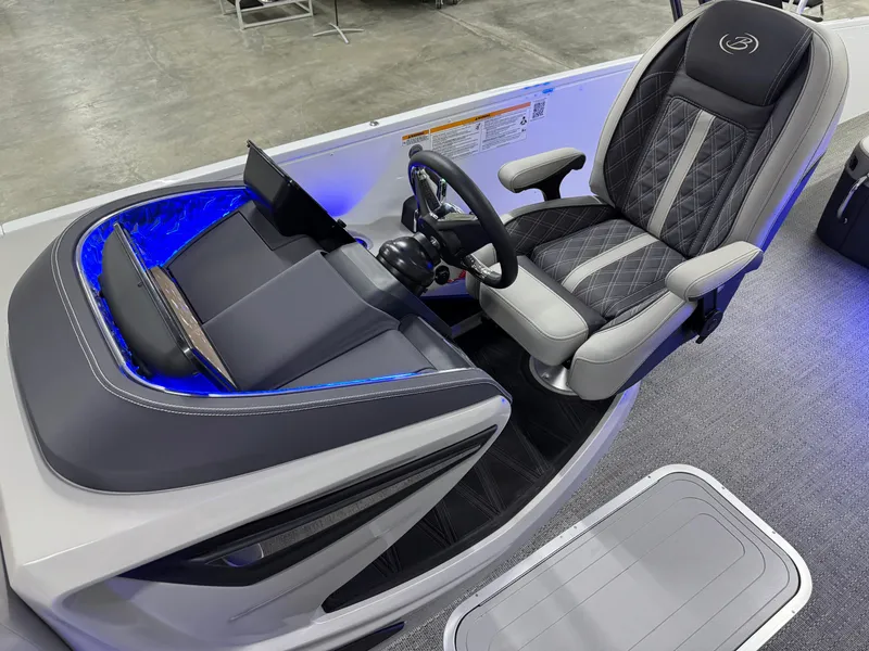 Slide: The Image of 2025 Barletta Reserve Leggera R26UCA boat cockpit with modern steering and seating. - 35