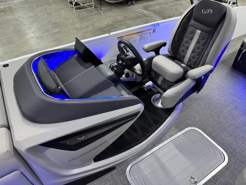 Slide: The Image of Captain's seat and helm of 2025 Barletta Reserve Leggera R26UCA with blue LED lighting. - 36