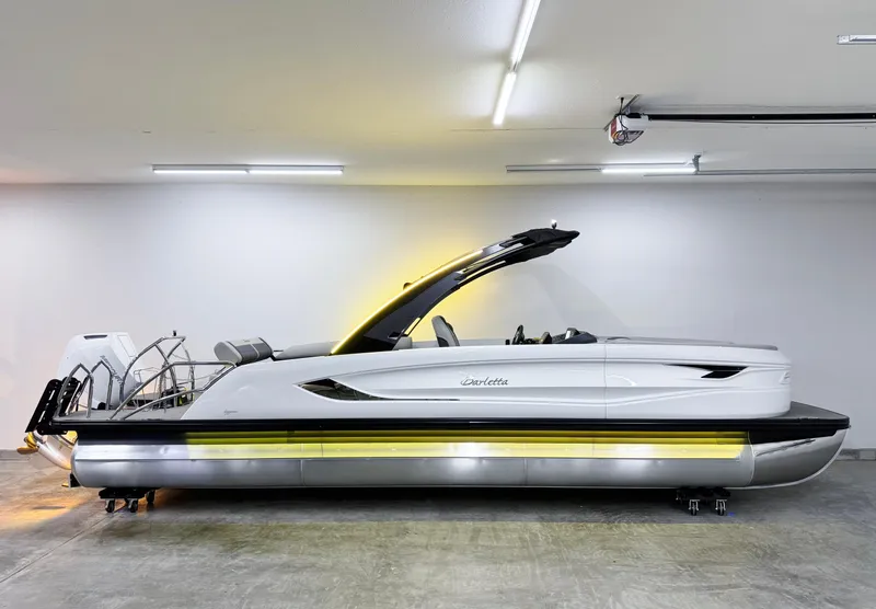 Slide: The Image of 2025 Barletta Reserve Leggera R26UCA pontoon boat in a modern garage setting. - 6