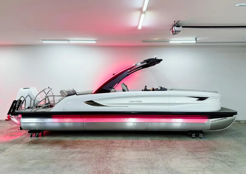 Slide: The Image of 2025 Barletta Reserve Leggera R26UCA pontoon boat with sleek design and red underglow lighting. - 7