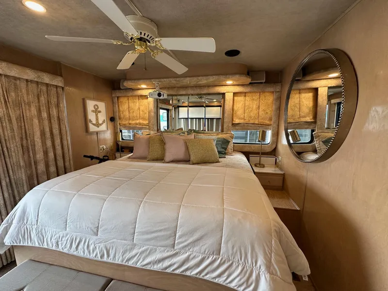 Slide: The Image of Cozy bedroom in 1994 Sumerset 16x73 houseboat with ceiling fan and nautical decor. - 12