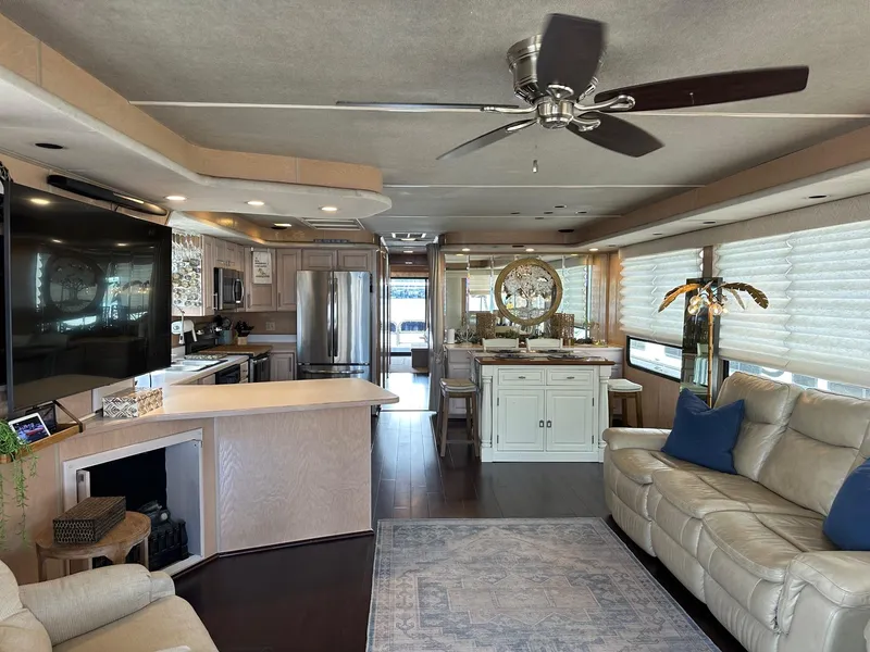Slide: The Image of Luxurious interior of a 1994 Sumerset 16x73 houseboat with modern kitchen and cozy seating. - 2