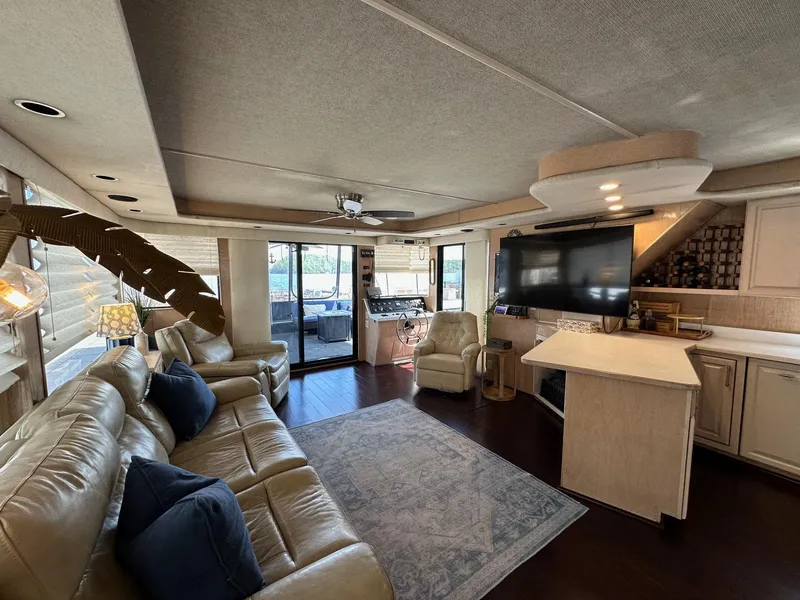 Slide: The Image of Luxurious interior of a 1994 Sumerset 16x73 houseboat with leather seating and modern amenities. - 3