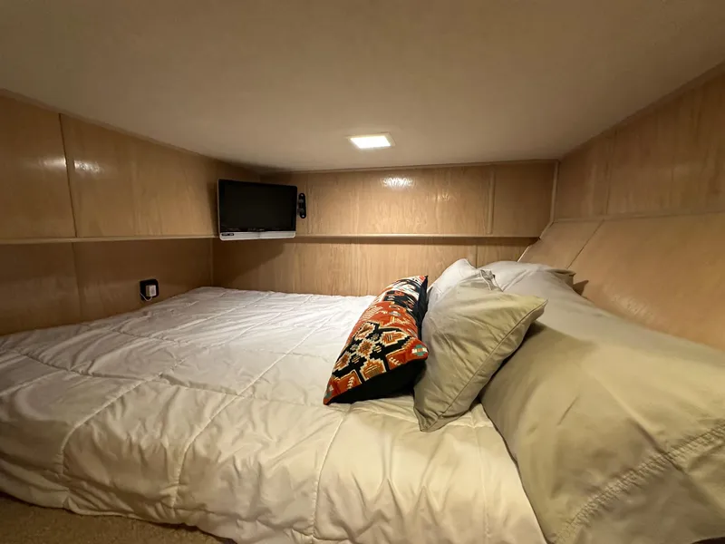 Slide: The Image of Cozy bedroom in 1994 Sumerset 16x73 houseboat with TV and decorative pillows. - 7