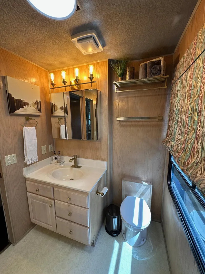 Slide: The Image of Bathroom interior of a 1994 Sumerset 16x73 houseboat with vanity and natural light. - 9