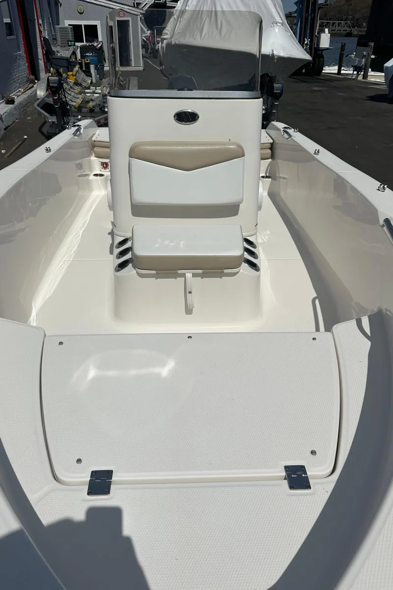 Slide: The Image of 2021 Robalo R160 Center Console boat with sleek white interior design. - 21