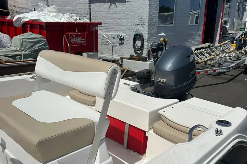 Slide: The Image of 2021 Robalo R160 Center Console boat with Yamaha 70 engine, docked outdoors. - 23