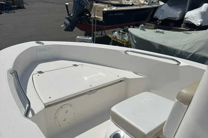 Slide: The Image of 2021 Robalo R160 Center Console boat interior with seating and storage. - 25