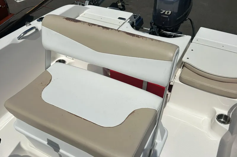 Slide: The Image of 2021 Robalo R160 Center Console boat seat with beige and white upholstery. - 27