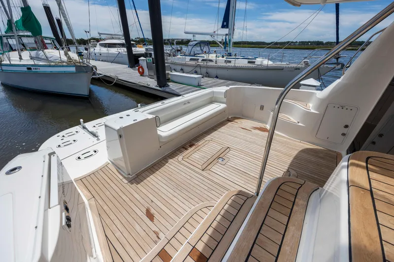 Slide: The Image of 2008 Sea Ray 58 Sedan Bridge yacht with spacious teak deck at marina. - 13