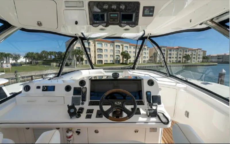 Slide: The Image of Helm of 2008 Sea Ray 58 Sedan Bridge yacht with modern controls and waterfront view. - 14
