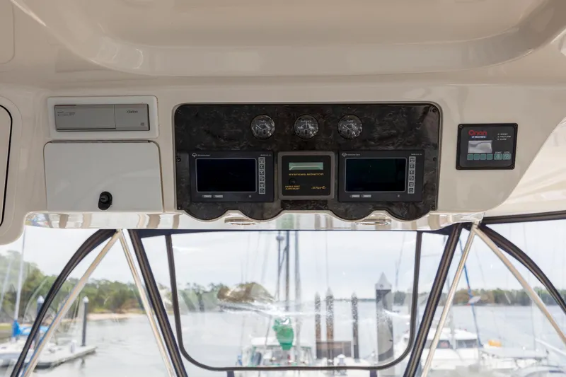 Slide: The Image of 2008 Sea Ray 58 Sedan Bridge helm with navigation displays and controls. - 17