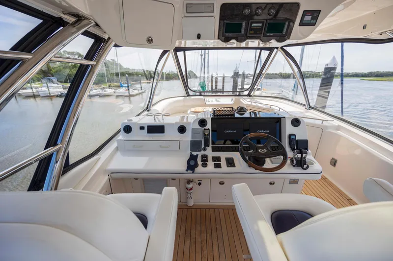 Slide: The Image of 2008 Sea Ray 58 Sedan Bridge helm with modern controls and panoramic view. - 18