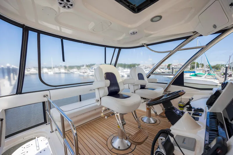 Slide: The Image of 2008 Sea Ray 58 Sedan Bridge helm with panoramic marina view and luxurious seating. - 19