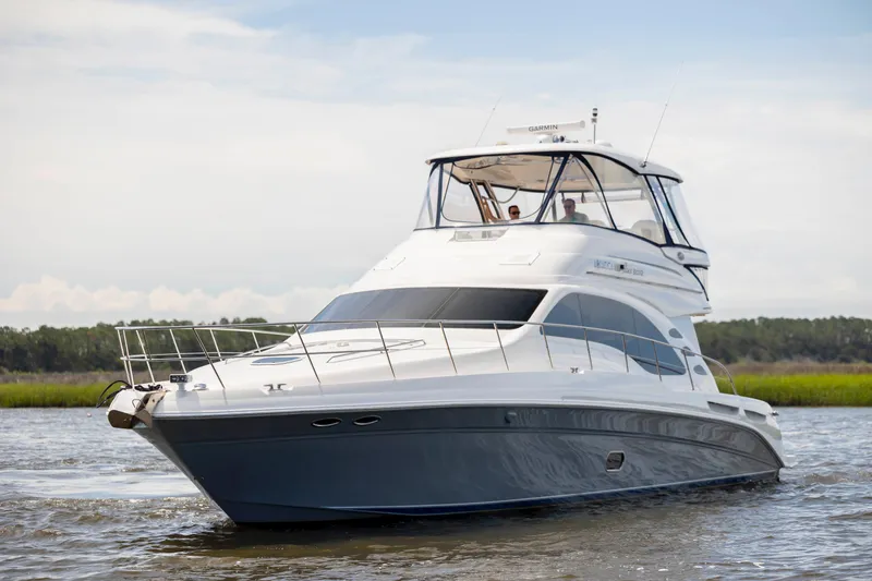 Slide: The Image of 2008 Sea Ray 58 Sedan Bridge yacht cruising on calm waters. - 2