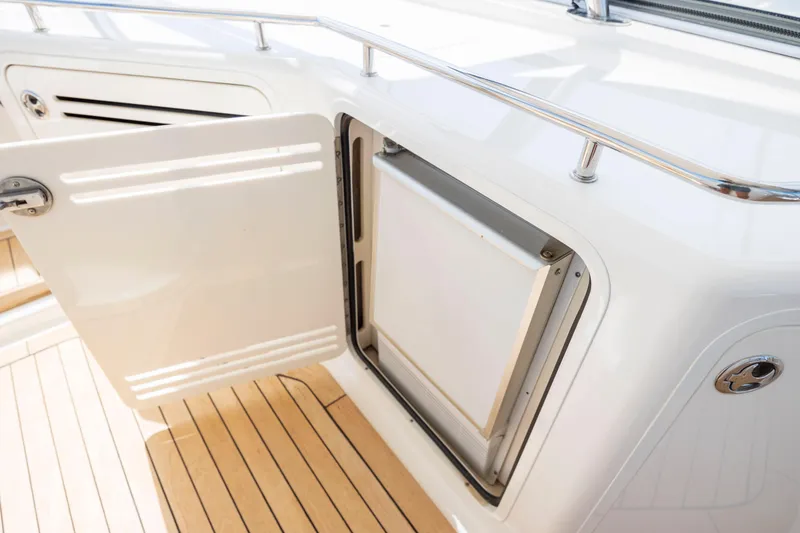 Slide: The Image of 2008 Sea Ray 58 Sedan Bridge yacht interior with open storage compartment. - 25