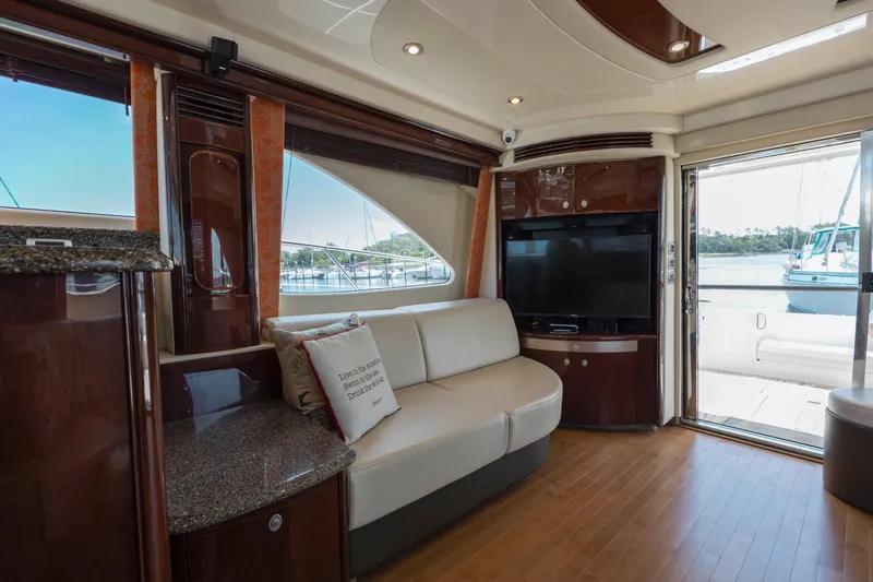 Slide: The Image of Luxurious interior of 2008 Sea Ray 58 Sedan Bridge yacht with modern furnishings and large windows. - 30