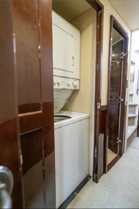 Slide: The Image of 2008 Sea Ray 58 Sedan Bridge yacht interior with stacked washer and dryer unit. - 47