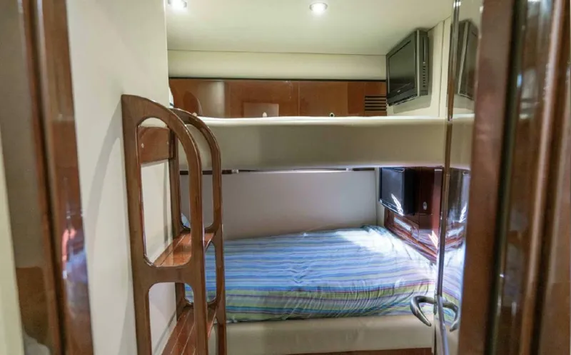 Slide: The Image of Interior of 2008 Sea Ray 58 Sedan Bridge with bunk beds and wooden finishes. - 48