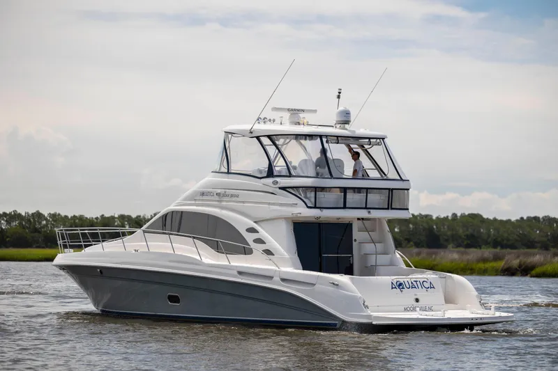Slide: The Image of 2008 Sea Ray 58 Sedan Bridge yacht cruising on a calm waterway. - 5