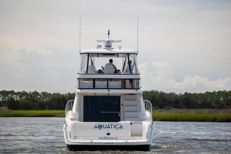 Slide: The Image of 2008 Sea Ray 58 Sedan Bridge yacht cruising on a calm waterway. - 6