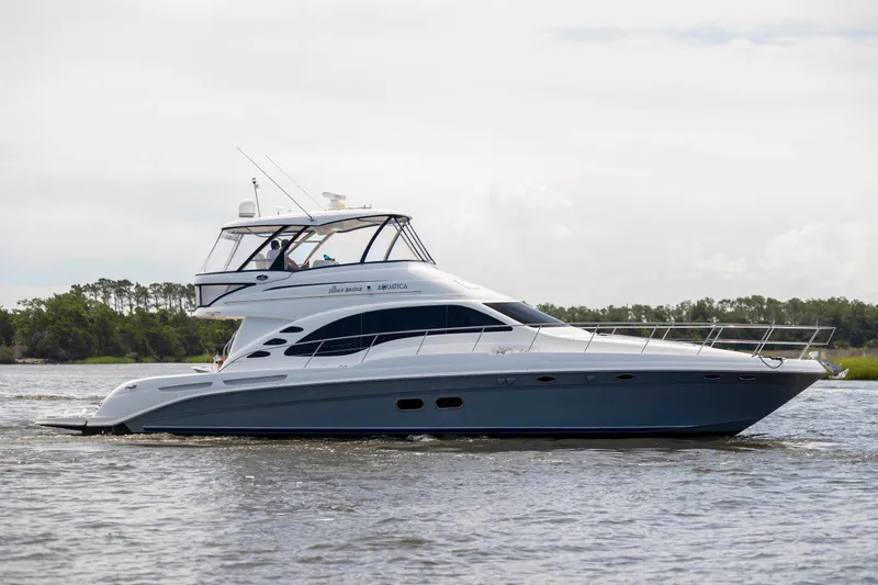 Slide: The Image of 2008 Sea Ray 58 Sedan Bridge yacht cruising on a calm waterway. - 8