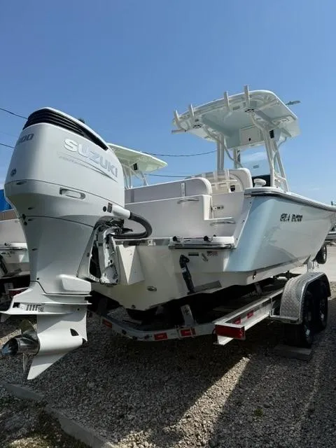 Slide: The Image of 2025 Sea Born LX24 Center Console boat with Suzuki outboard engine on trailer. - 2