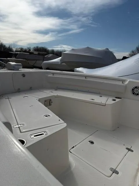 Slide: The Image of 2025 Sea Born LX24 Center Console boat interior under a partly cloudy sky. - 21